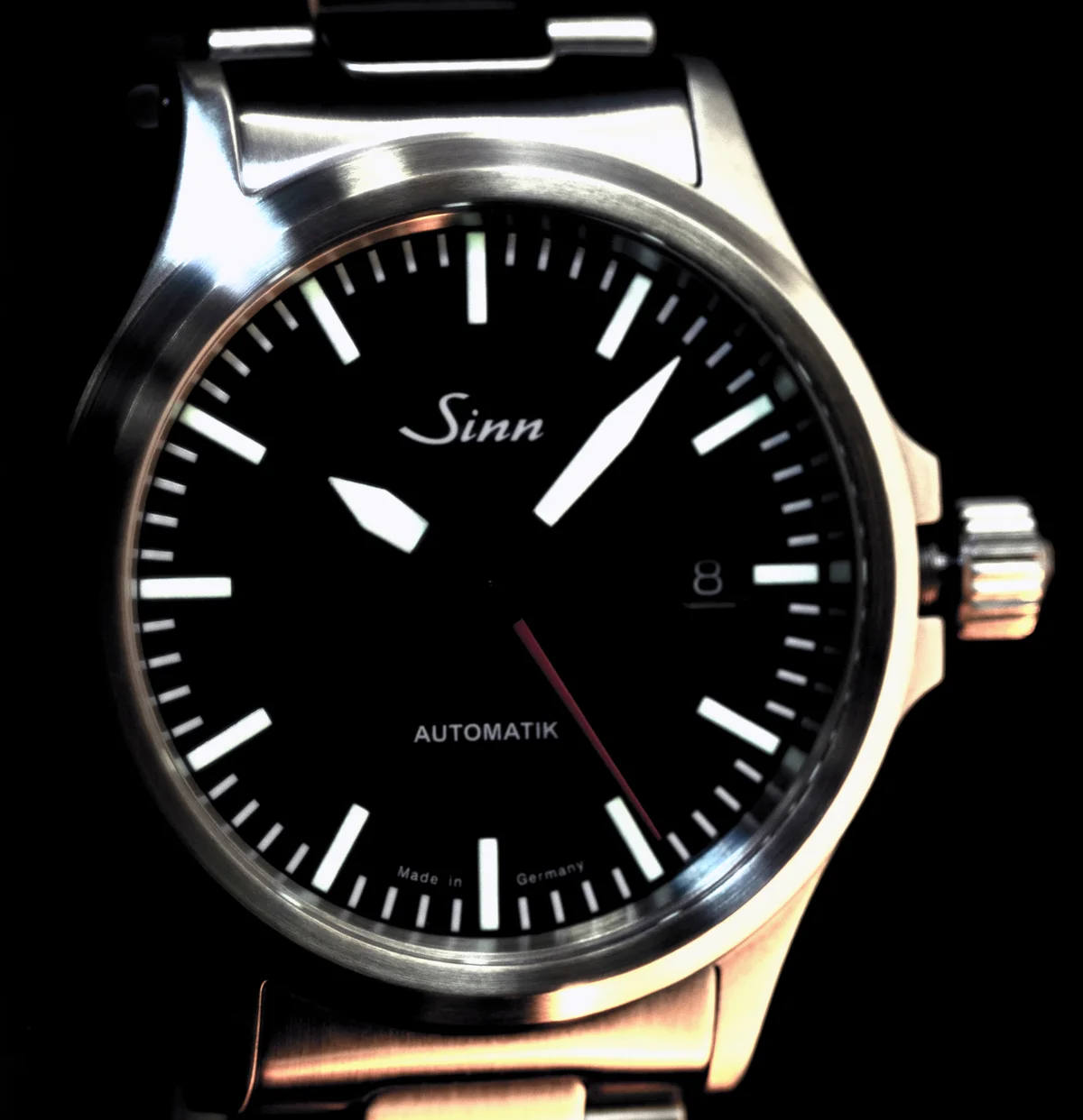 The 556 I RS dial straight on: glossy black, white baton markers, date at three, AUTOMATIK and Made in Germany printed below centre, red seconds hand.